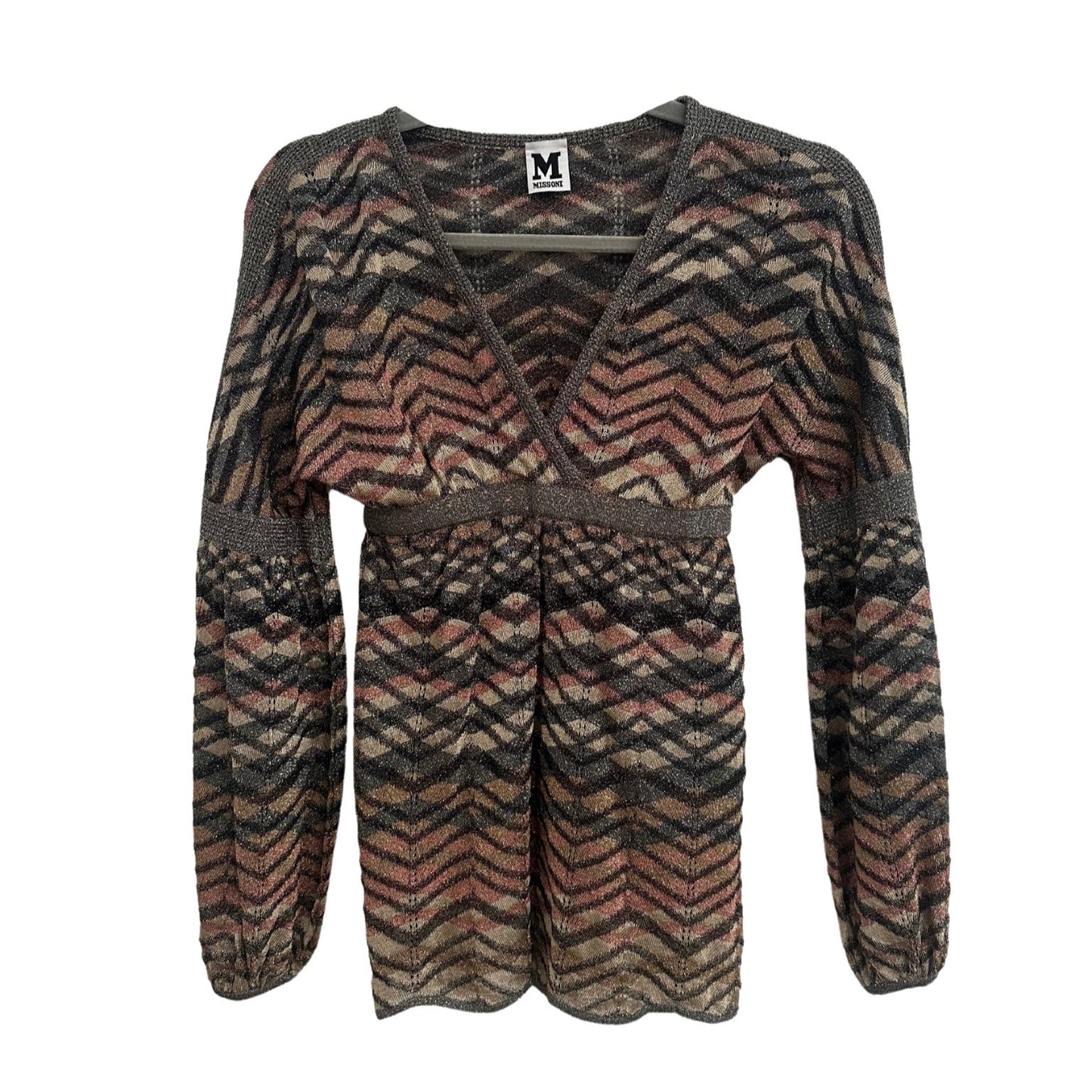A Missoni 90s balloon sleeve top displayed from the front on a hanger. The top features a deep V-neckline with metallic trim, an empire waist with a fitted band, and long voluminous sleeves that gather at the cuffs. The knit fabric showcases a signature Missoni zigzag pattern in earthy tones of brown, beige, and muted pink with subtle metallic threading. The silhouette is slightly flared at the hem, creating a flowy effect, while the textured knit adds depth to the design.
