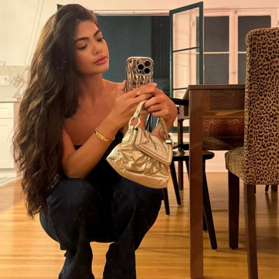Fashion influencer holding a 2004 Fendi Metallic Napa Mini Chef Shoulder Bag in gold, paired with casual chic styling, highlighting its versatility and timeless luxury in a modern lifestyle setting.