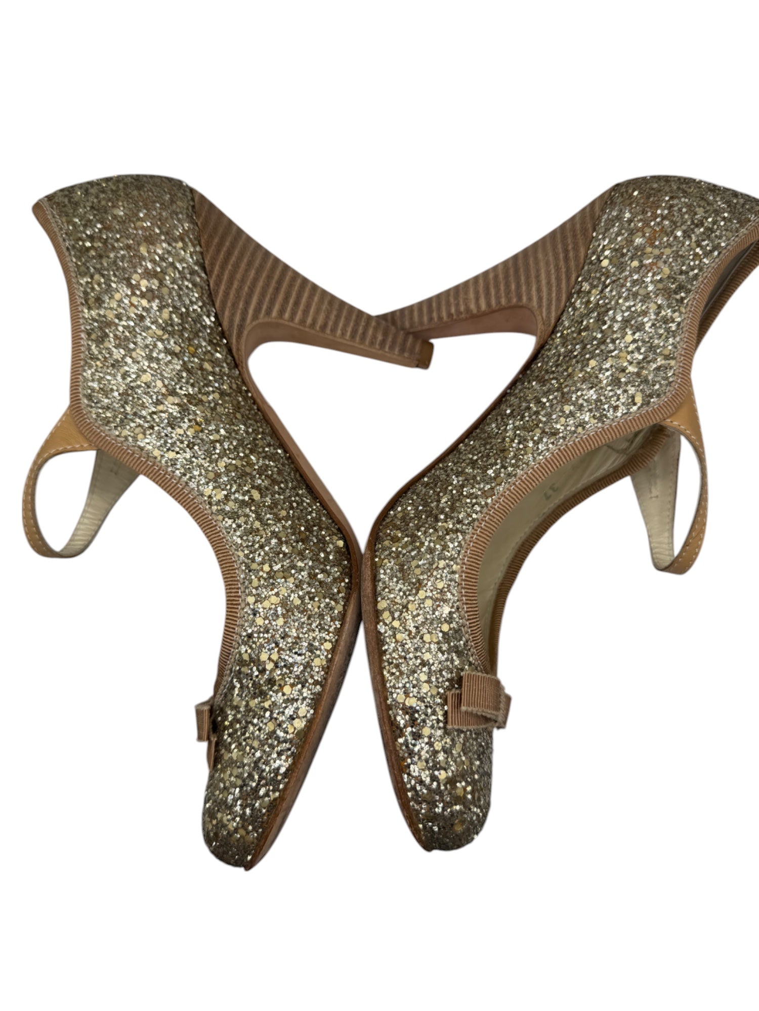 Pair of glittery high-heeled shoes on a white background