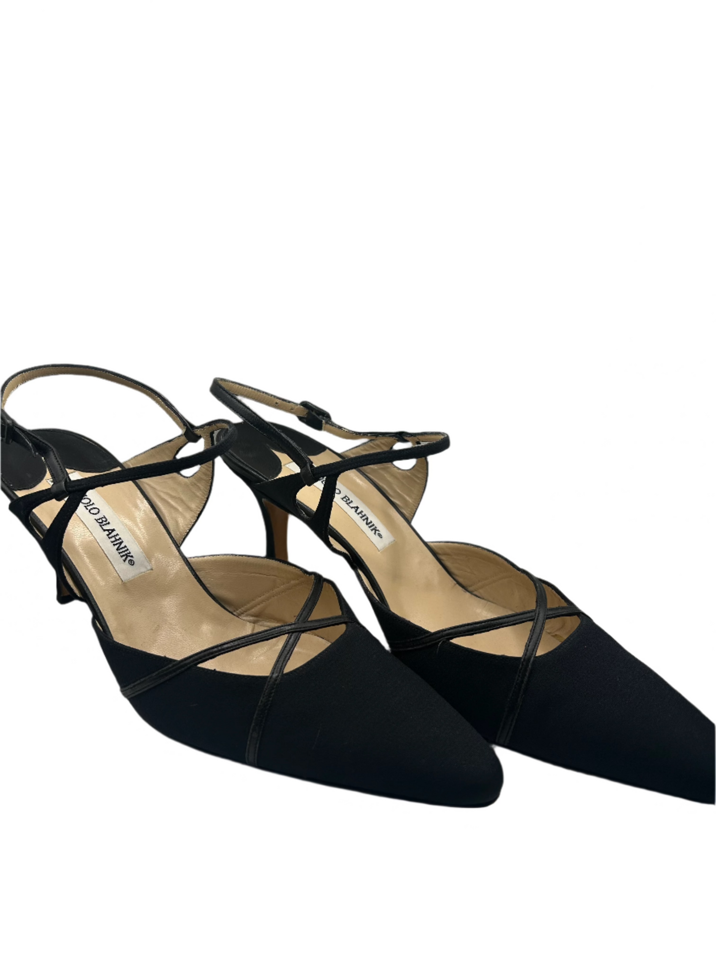 Angled front view of a pair of Manolo Blahnik black satin and canvas slingback heels featuring a pointed toe, crisscross strap detailing, and an adjustable ankle strap. The elegant design showcases a subtle stiletto heel and a lightly cushioned insole with the Manolo Blahnik logo.