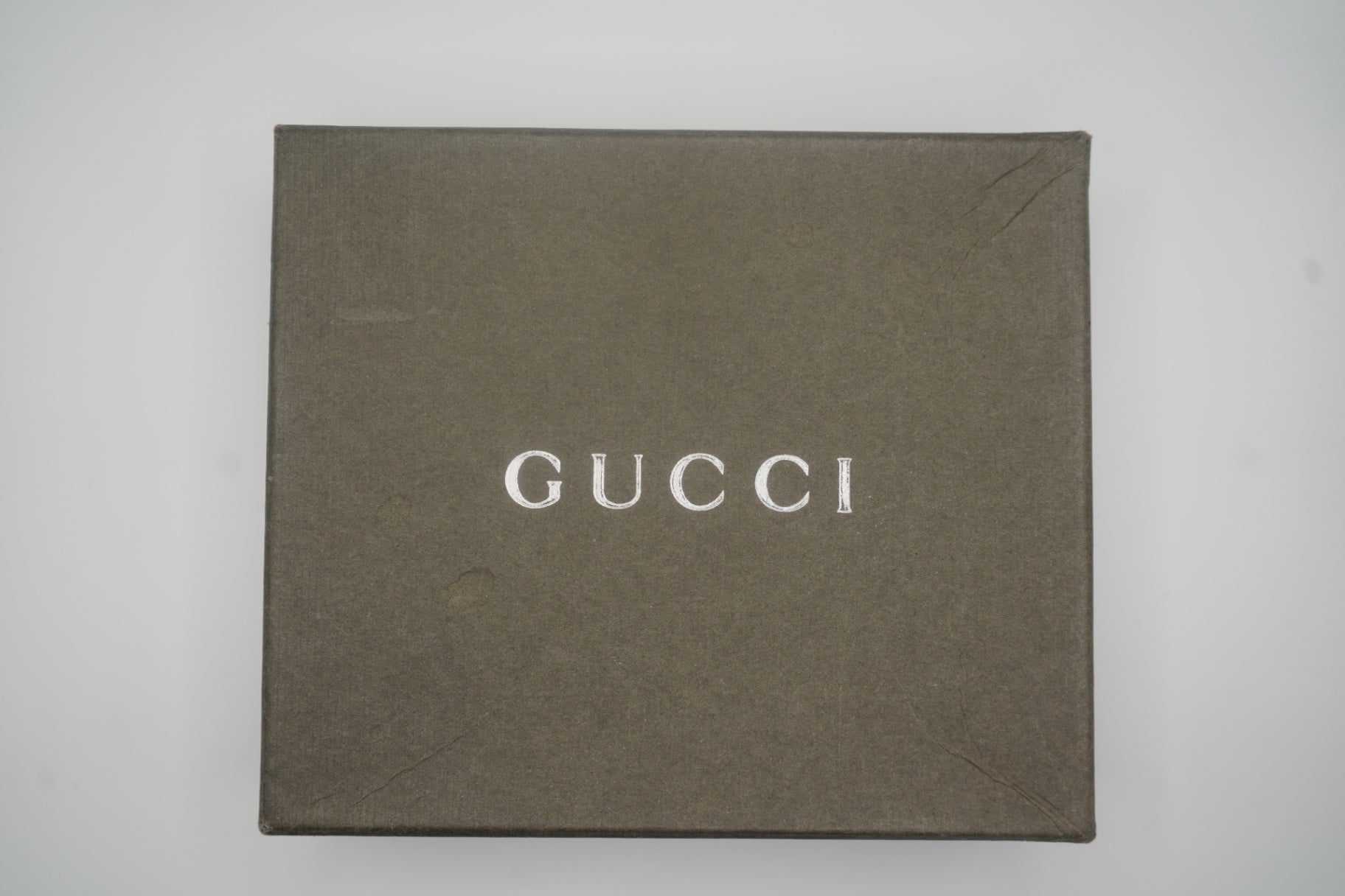 Front view of Green Gucci Wallet box showing silver text logo.