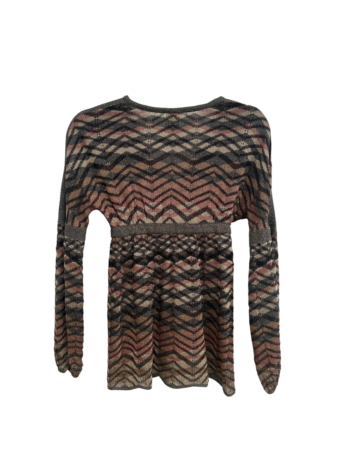 A vintage Missoni 1990s balloon sleeve top displayed from the back. The garment features a signature zigzag knit pattern in earthy tones of black, brown, beige, and muted pink. The fabric has a metallic sheen, and the top includes a cinched waistline with a horizontal band. The long balloon sleeves taper slightly at the cuffs, and the hemline falls loosely, creating a relaxed silhouette.