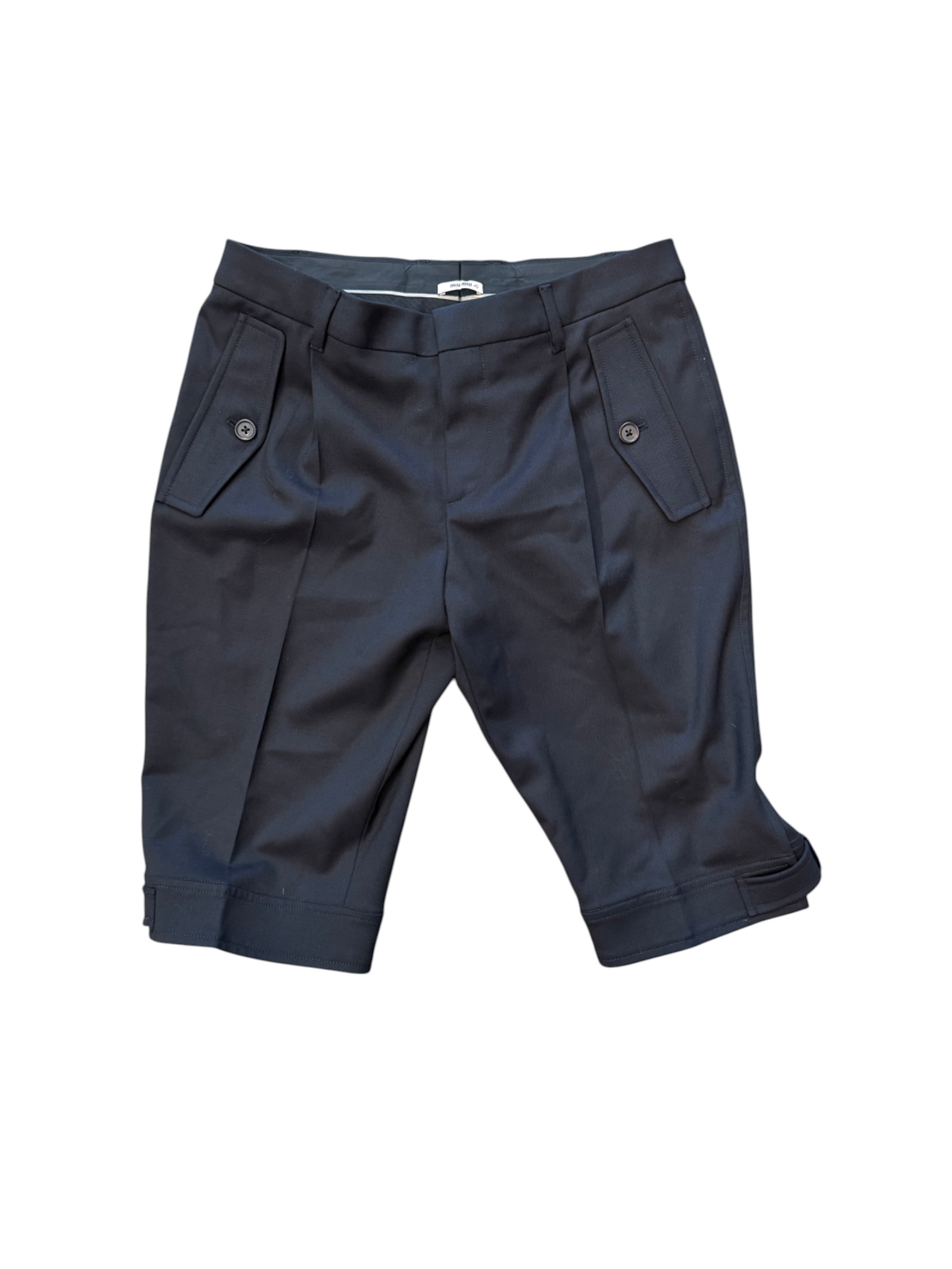Folded navy blue pants on a white background
