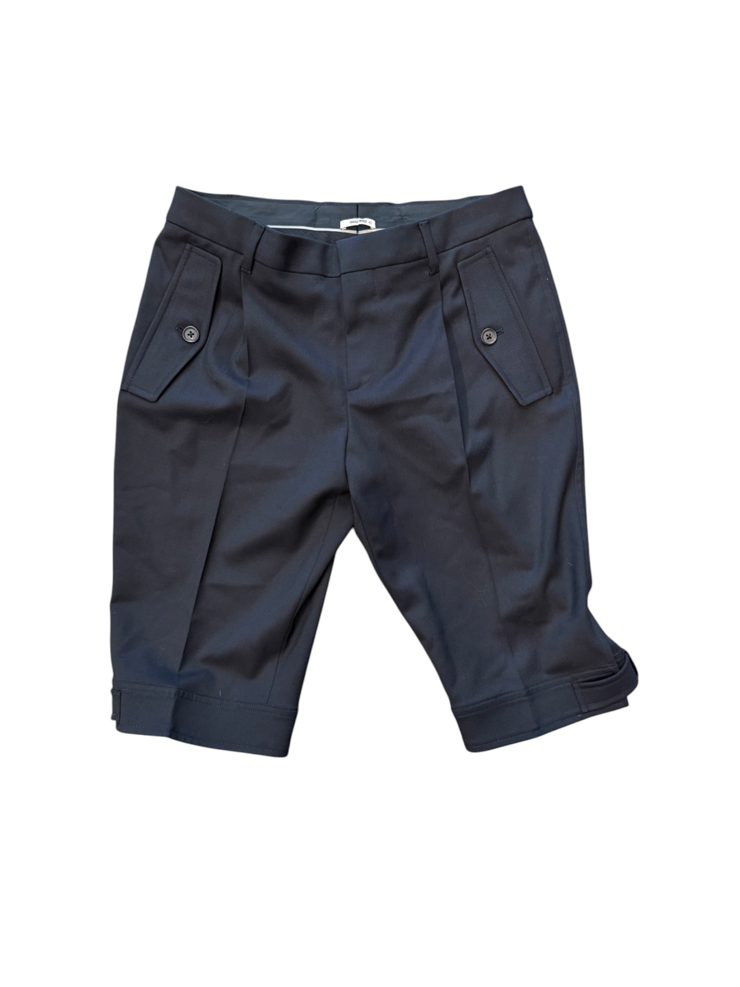 Folded navy blue pants on a white background