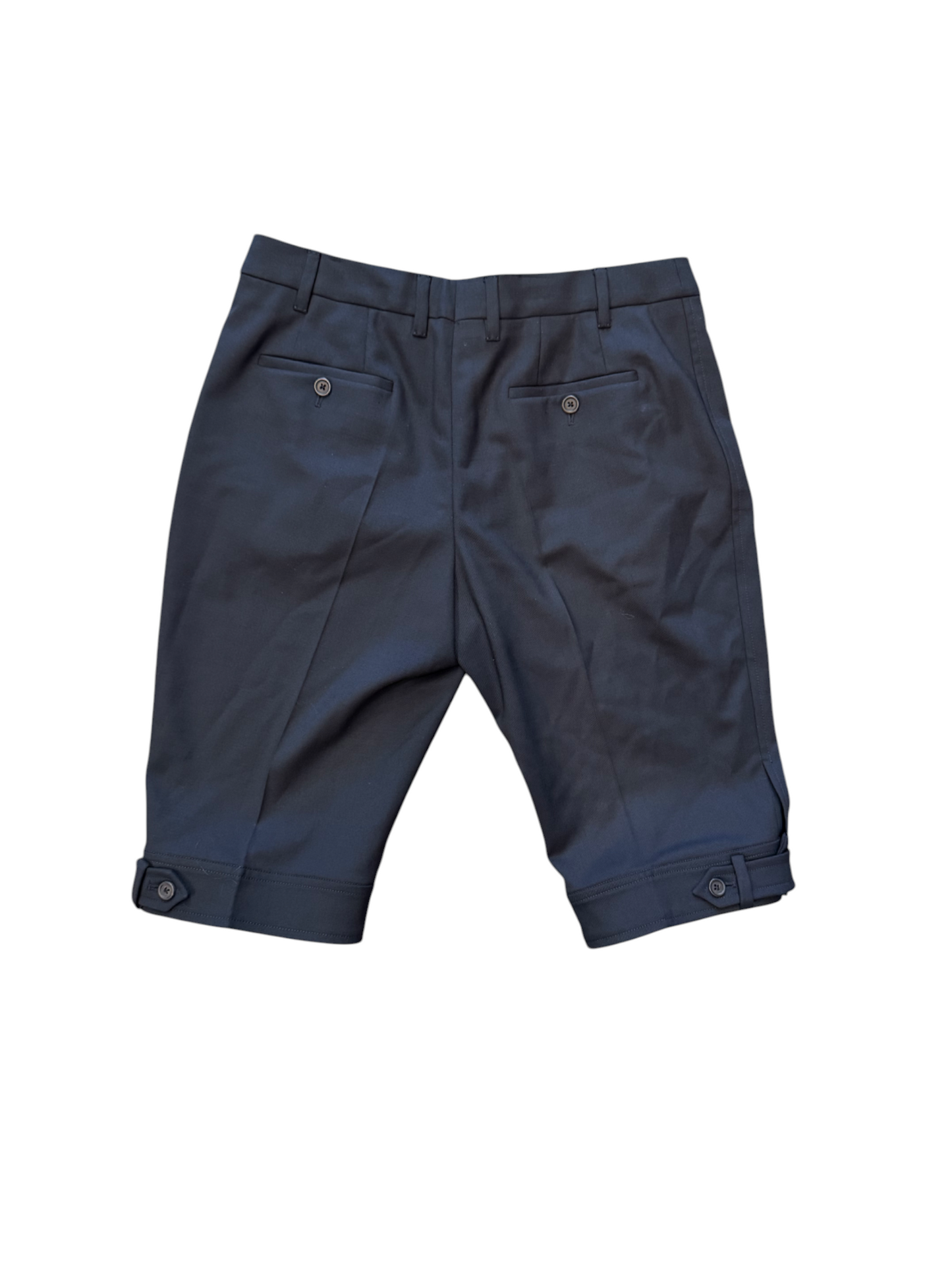 Folded navy blue pants on a white background
