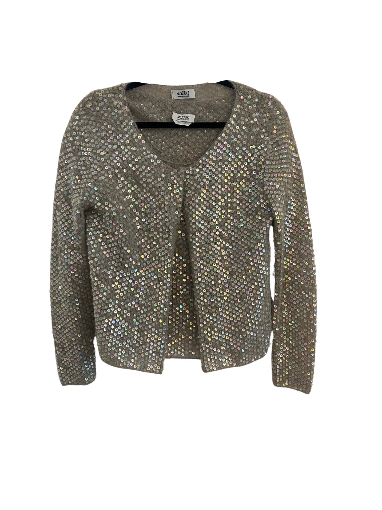 A Moschino sequin twin sweater/top set displayed flat. The top is a gray knit sweater adorned with iridescent sequins covering the entire front and back. The garment has a V-neckline and long sleeves, with the sequins reflecting light in varying hues. The sweater is shown open at the front, highlighting the sparkling, embellished design.